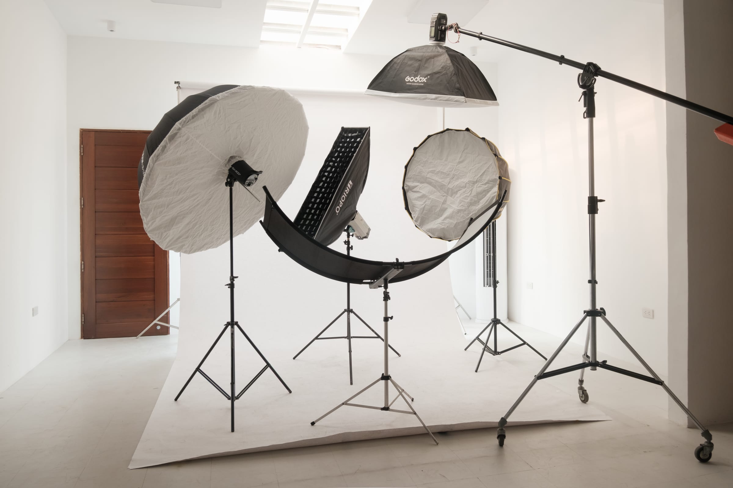 Main studio with professional lighting setup — softboxes and seamless backdrop